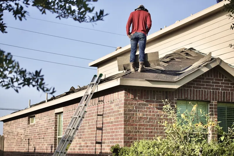 Professional roofer working on a residential roof in Navesink Beach